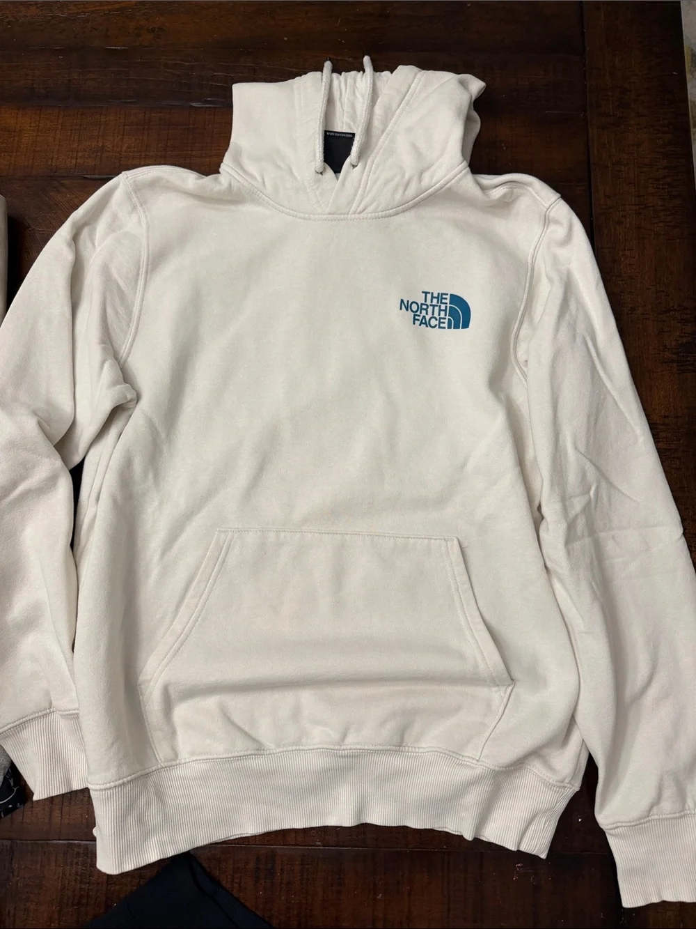 The North Face Men's Cream Hoodie with Blue Logo